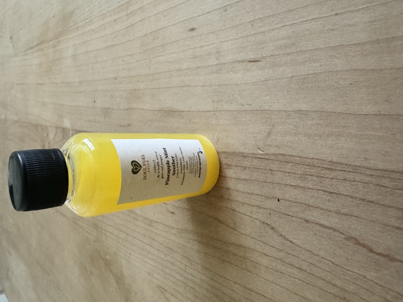 Healing Greens cold-pressed juice bottle in a natural setting